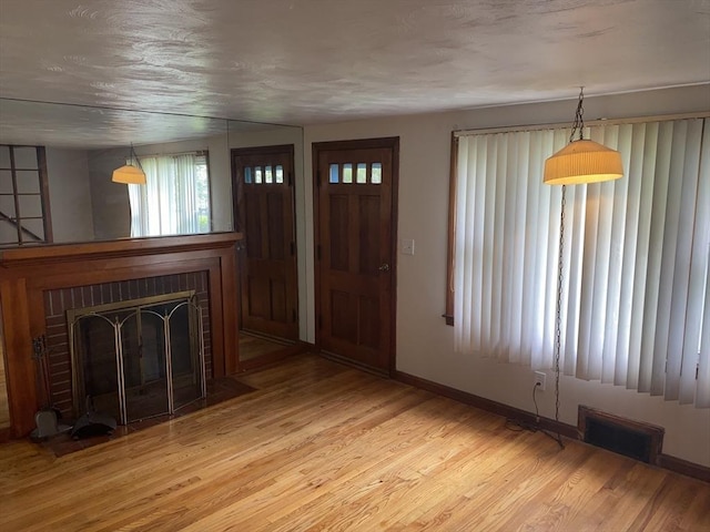 107 Rollins St, Springfield, MA 01109 - entryway with wood finished floors and a fireplace