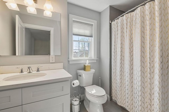 full bathroom featuring toilet, baseboards, tile patterned flooring, and vanity