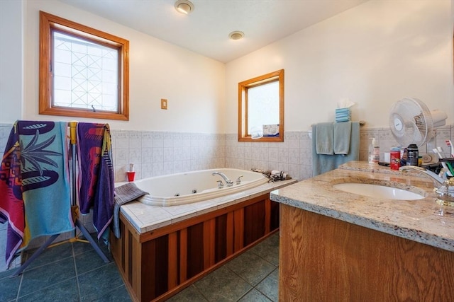 1-3 Fairoaks Ave, Methuen, MA 01844 - bathroom with tile patterned flooring, a wainscoted wall, a tub with jets, vanity, and tile walls