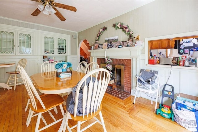 1-3 Fairoaks Ave, Methuen, MA 01844 - dining space with ceiling fan, a brick fireplace, crown molding, and parquet flooring