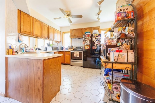 1-3 Fairoaks Ave, Methuen, MA 01844 - kitchen featuring black appliances, a ceiling fan, a sink, light countertops, and a peninsula