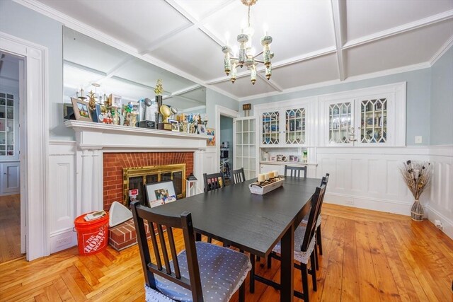 1-3 Fairoaks Ave, Methuen, MA 01844 - dining room with a chandelier, a fireplace, coffered ceiling, wainscoting, and a decorative wall