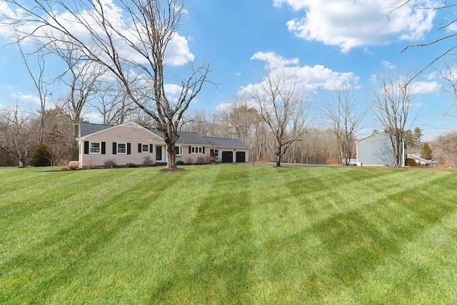 exterior space featuring an attached garage and a front lawn