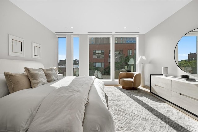 bedroom featuring expansive windows and recessed lighting