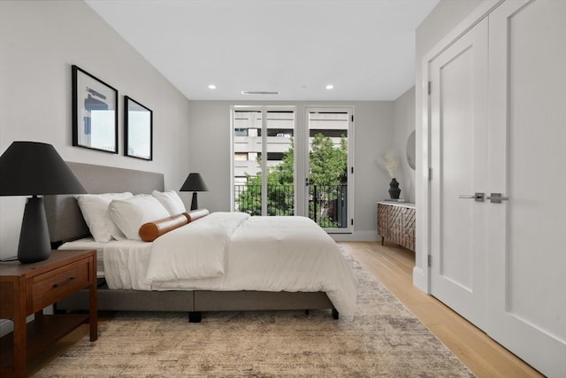 bedroom with recessed lighting and light wood-style flooring