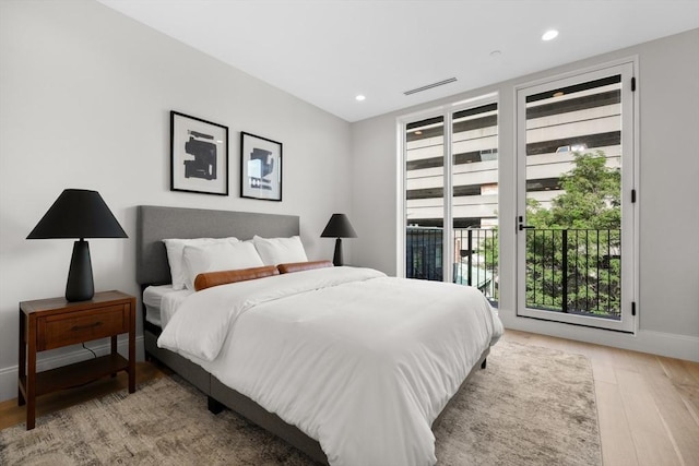 bedroom with access to exterior, light wood finished floors, recessed lighting, visible vents, and baseboards