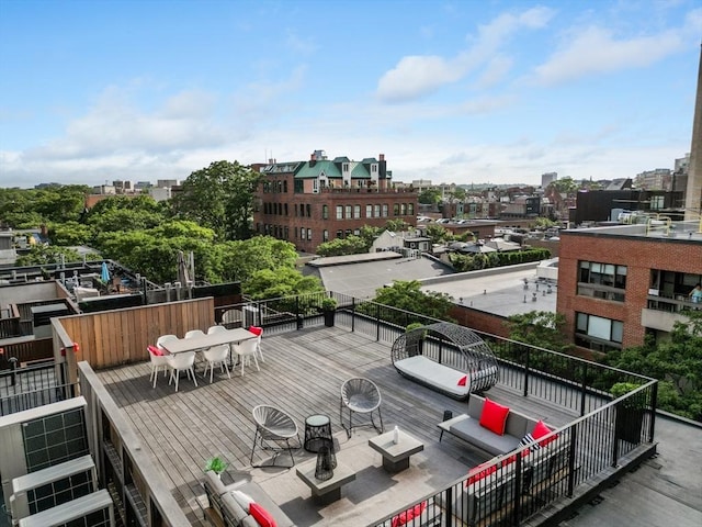 deck featuring a view of city and outdoor dining area