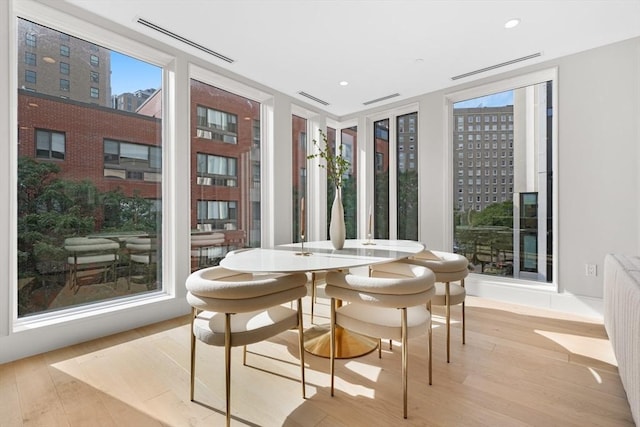 sunroom featuring radiator and visible vents