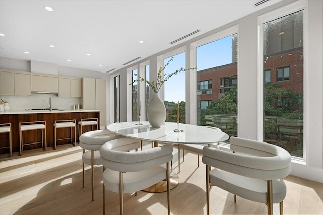 sunroom with visible vents and a sink