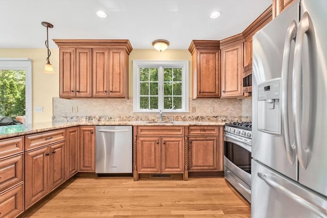 80 Schooner Ln, Barnstable, MA 02601 - kitchen with appliances with stainless steel finishes, a sink, brown cabinets, and recessed lighting
