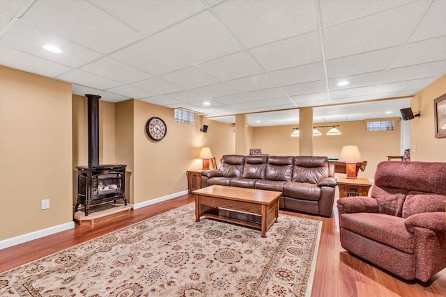 80 Schooner Ln, Barnstable, MA 02601 - living room featuring wood finished floors, a wood stove, a drop ceiling, baseboards, and recessed lighting