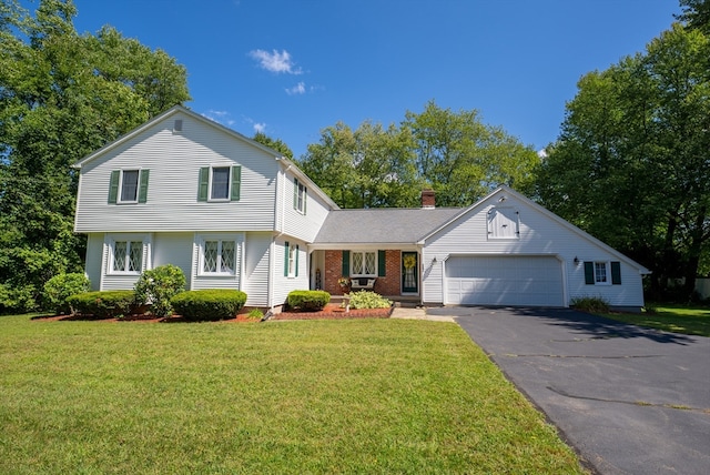 view of front of property with a front yard and a garage