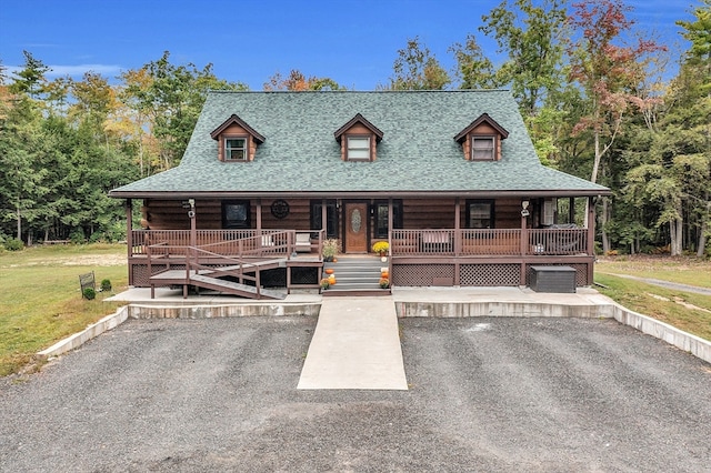 log-style house with a front lawn and a porch