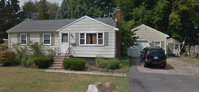 221 Ruthellen Rd, Bellingham, MA 02019 - ranch-style house with a chimney, asphalt driveway, an outdoor structure, and a front yard
