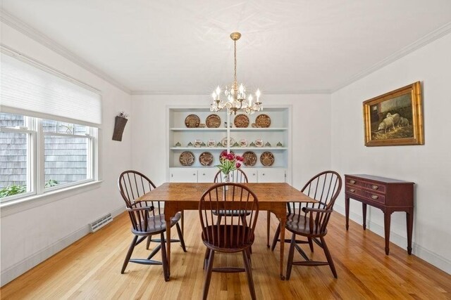 307 Riverview Dr, Chatham, MA 02633 - dining space featuring an inviting chandelier, visible vents, light wood-style floors, crown molding, and baseboards