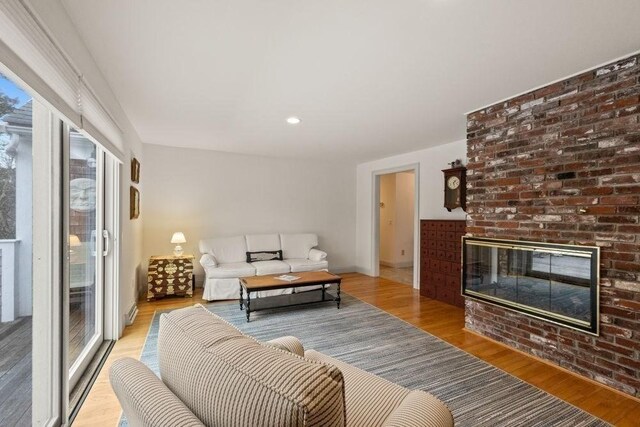 307 Riverview Dr, Chatham, MA 02633 - living area featuring baseboards, light wood-style floors, and a fireplace