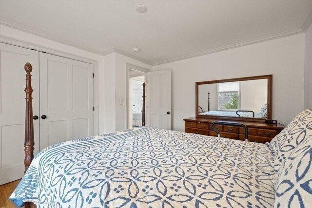 307 Riverview Dr, Chatham, MA 02633 - bedroom with wood finished floors, a closet, and ornamental molding