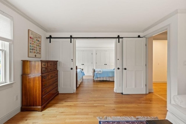 307 Riverview Dr, Chatham, MA 02633 - hall with a barn door, ornamental molding, and light wood finished floors