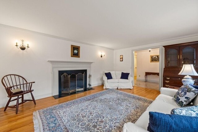 307 Riverview Dr, Chatham, MA 02633 - living room with baseboards, crown molding, wood finished floors, and a fireplace