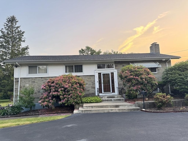 127 Sumner St, Milton, MA 02186 - raised ranch featuring stone siding and a chimney