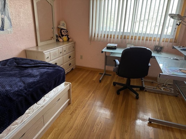127 Sumner St, Milton, MA 02186 - bedroom featuring light wood-type flooring, a textured wall, an office area, and baseboards