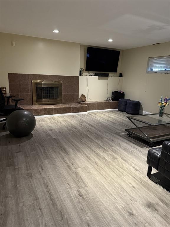 127 Sumner St, Milton, MA 02186 - living area with wood finished floors, a fireplace, and recessed lighting
