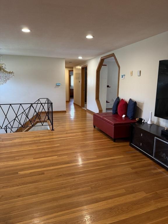 127 Sumner St, Milton, MA 02186 - hall featuring wood finished floors, recessed lighting, a chandelier, arched walkways, and baseboards