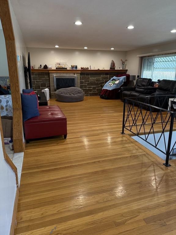 127 Sumner St, Milton, MA 02186 - living area featuring wood finished floors, recessed lighting, and a stone fireplace
