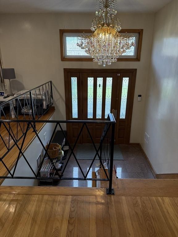 127 Sumner St, Milton, MA 02186 - foyer with baseboards and a chandelier