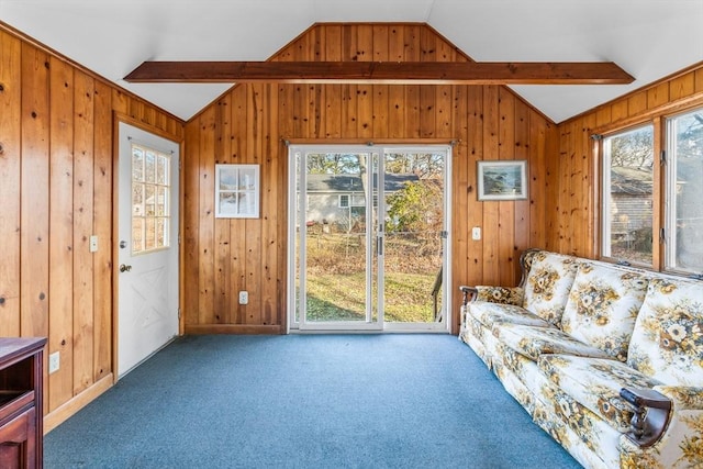 living room featuring carpet, wood walls, and lofted ceiling with beams