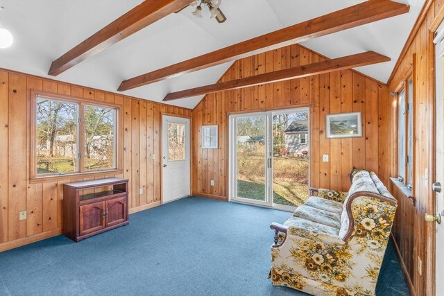 sunroom featuring vaulted ceiling with beams