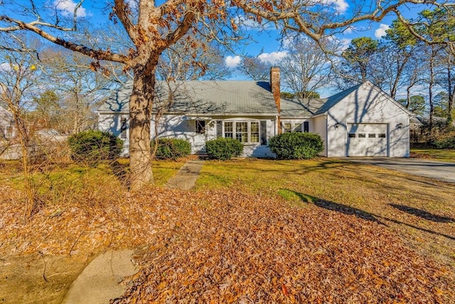 view of front of house with a front yard and a garage