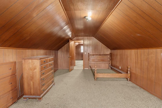 bonus room featuring light colored carpet, wooden walls, and vaulted ceiling