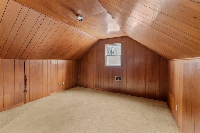 additional living space featuring wood ceiling, vaulted ceiling, and wood walls