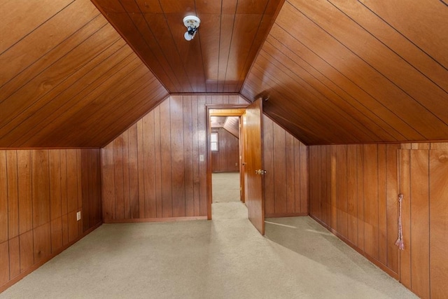 bonus room featuring light carpet, wooden walls, wooden ceiling, and lofted ceiling