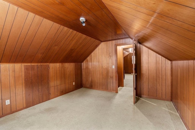 bonus room featuring light colored carpet, wooden ceiling, wooden walls, and lofted ceiling