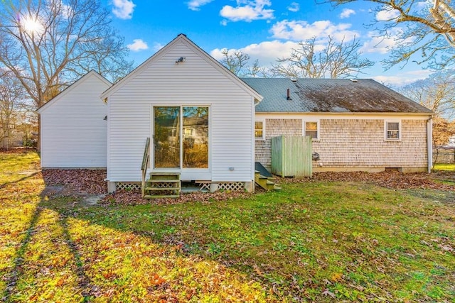 back of house with a lawn