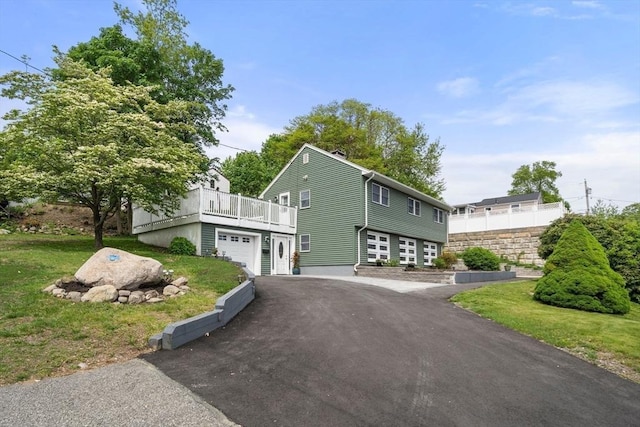 152 Audubon Ave, Braintree, MA 02184 - view of front facade with driveway, a front lawn, and a wooden deck