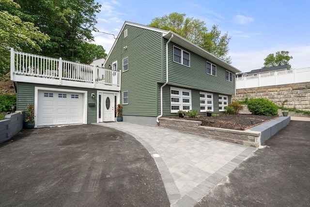 152 Audubon Ave, Braintree, MA 02184 - view of front of house with asphalt driveway, a garage, and a balcony
