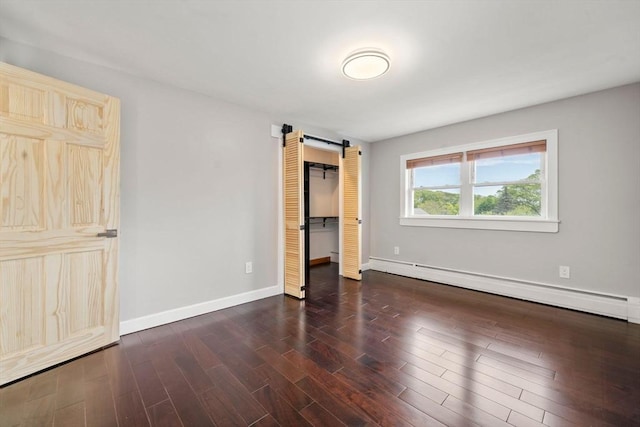 152 Audubon Ave, Braintree, MA 02184 - unfurnished bedroom featuring a barn door, wood finished floors, baseboards, baseboard heating, and a closet