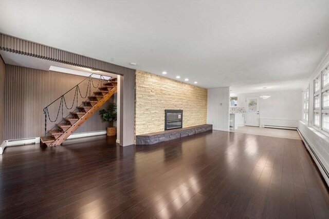 152 Audubon Ave, Braintree, MA 02184 - unfurnished living room featuring a stone fireplace, stairs, baseboard heating, and hardwood / wood-style floors
