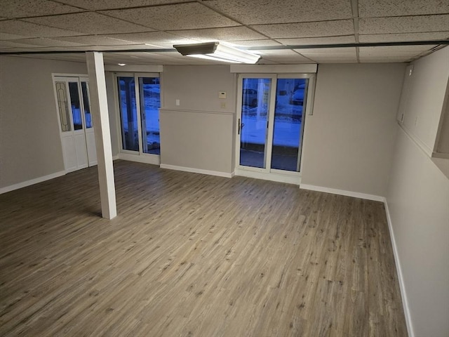 basement with hardwood / wood-style floors and a drop ceiling