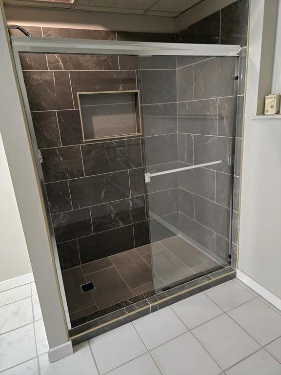 bathroom featuring tile patterned flooring and an enclosed shower