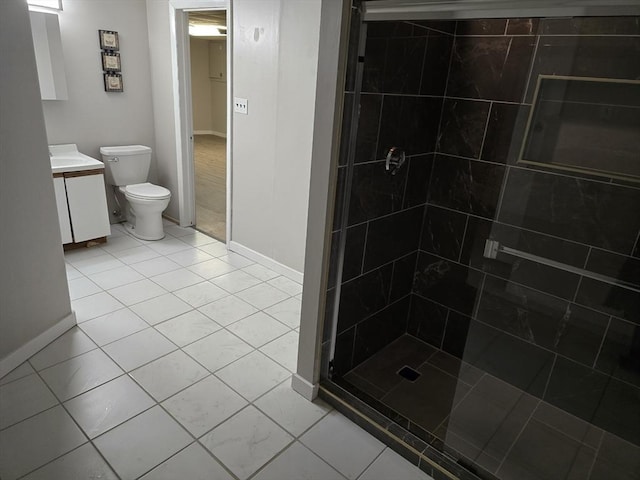 bathroom with walk in shower, vanity, toilet, and tile patterned flooring