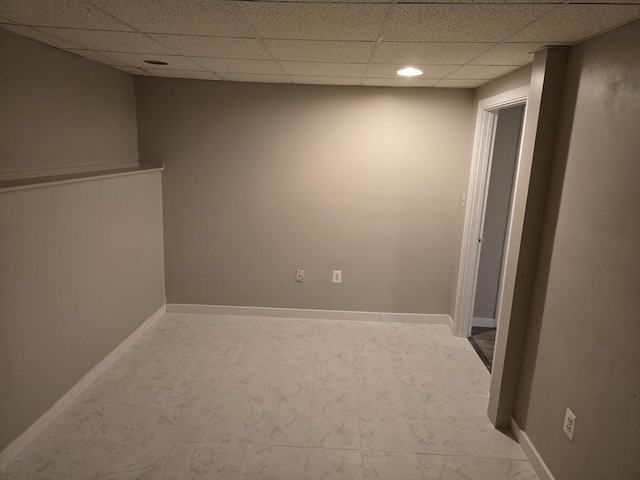 empty room featuring a paneled ceiling