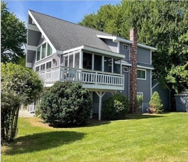 back of house featuring a lawn