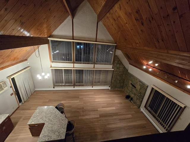 additional living space with wood ceiling, light hardwood / wood-style flooring, an inviting chandelier, beam ceiling, and high vaulted ceiling