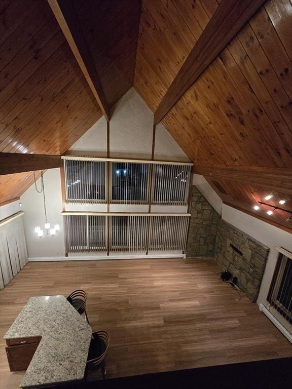 additional living space with high vaulted ceiling, beam ceiling, light wood-type flooring, and wooden ceiling