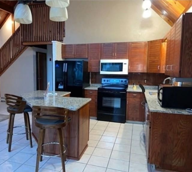 kitchen featuring a kitchen island, lofted ceiling, wood ceiling, black appliances, and light stone countertops