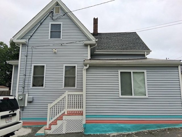 23 Barry St, Brockton, MA 02302 - rear view of property featuring a chimney and a shingled roof